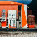Man sitting at a petrol station at night