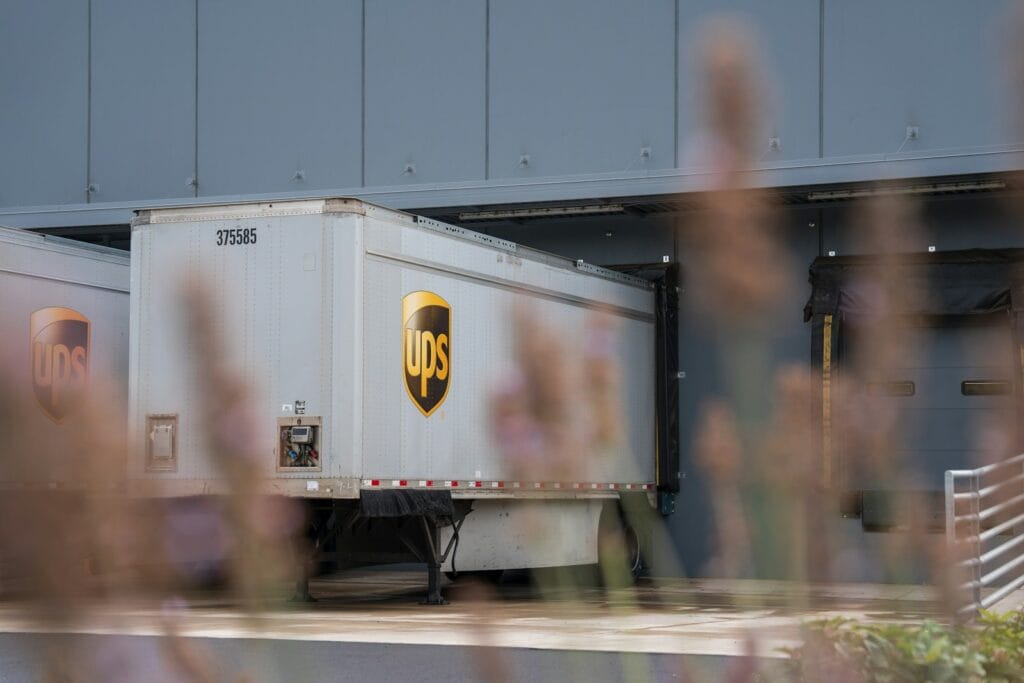 A truck is parked in front of a building