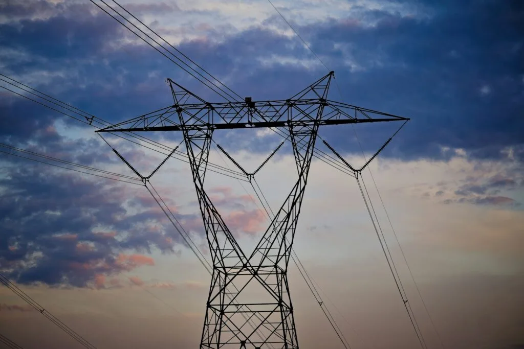 A tall electrical pylon against a cloudy sky